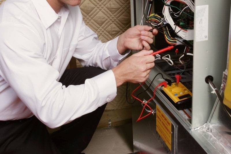 technician maintaining a heating system