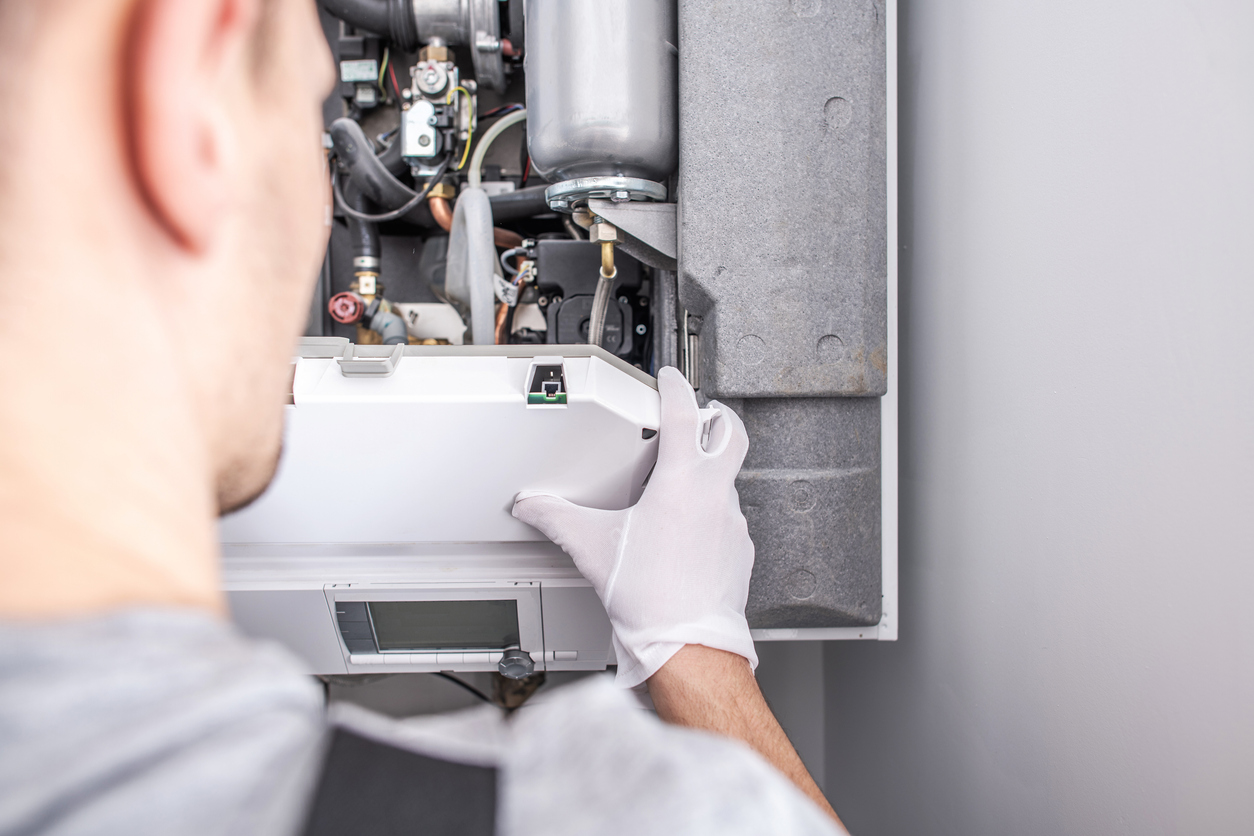 HVAC Contractor Repairing Central Heating Furnace System