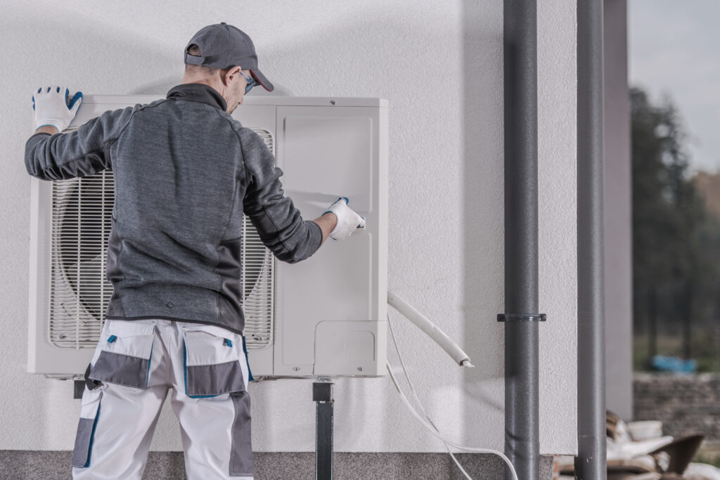 HVAC technician performing a maintenance service on a residential heat pump
