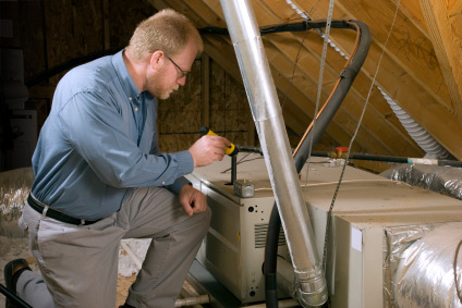 HVAC technician with heating system in attic