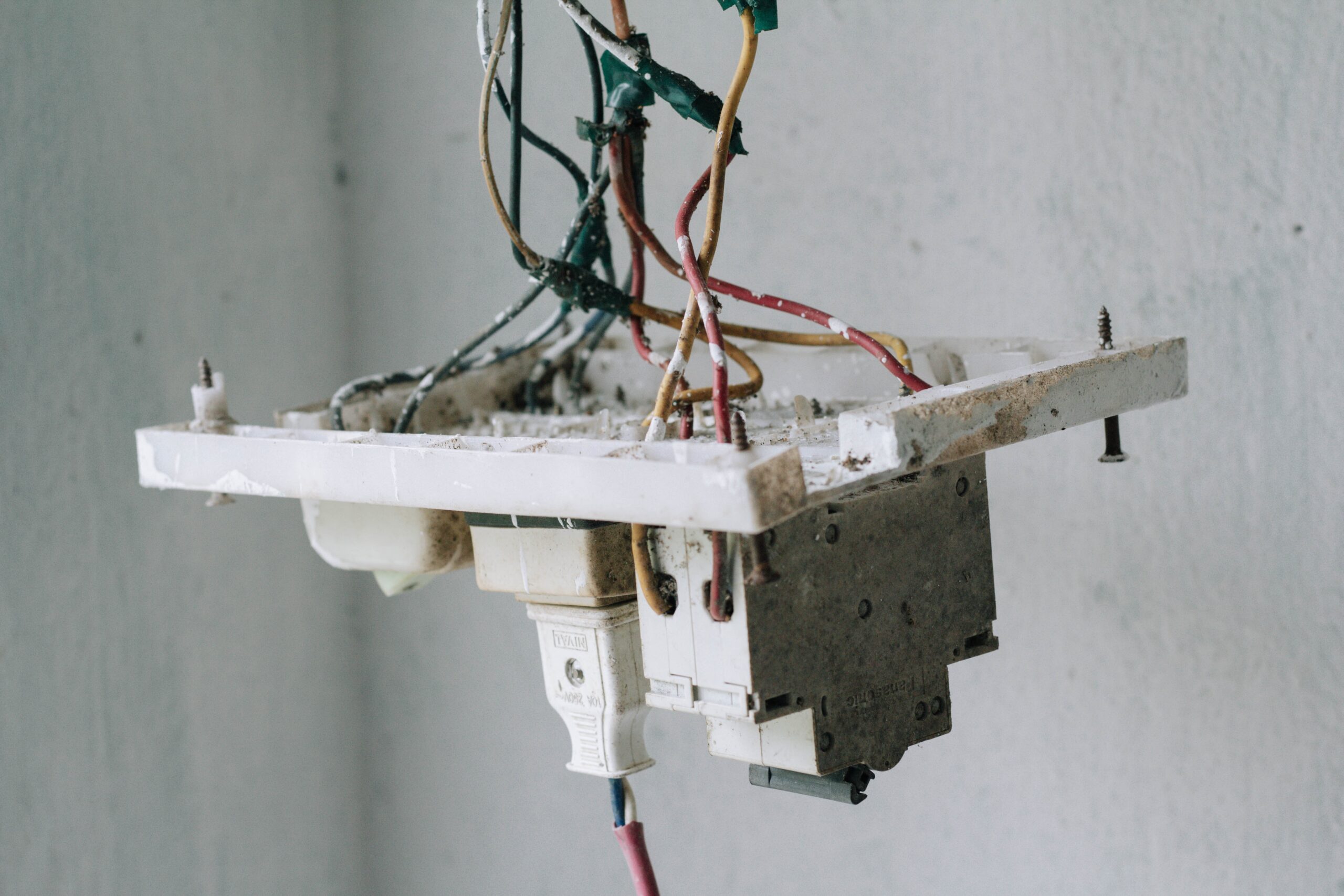 electrical outlet hanging out of wall by wires